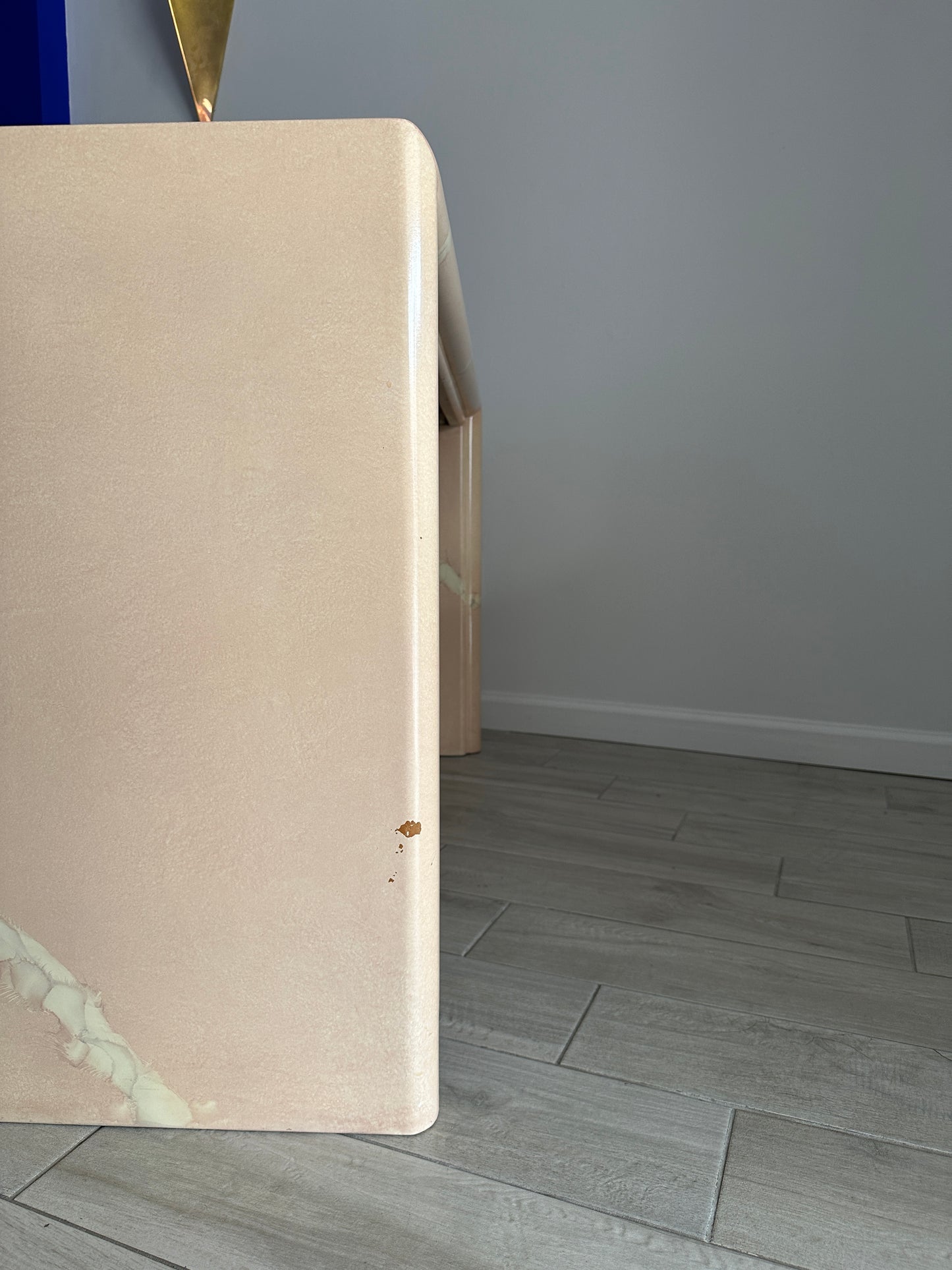 Vintage lacquered console table with a faux painted pink quartz marble top and a waterfall design on a light peachy pink background, with white marbling visible in the style of Karl Springer