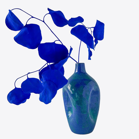 A vibrant blue and green North Carolina pottery pinch bottle vase with pinch sculptural detail.