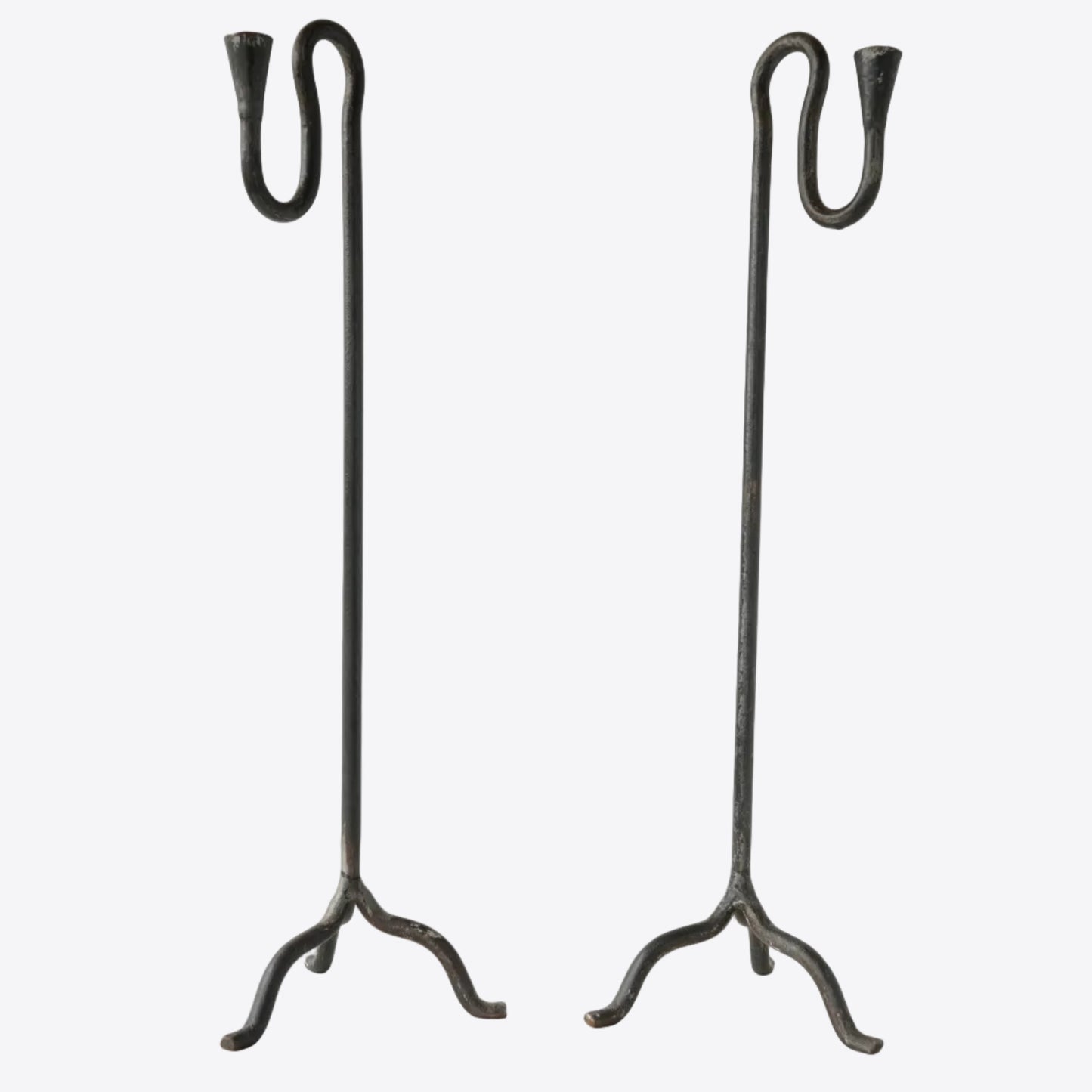 Pair of wrought iron hand-forged candle holders with sculptural squiggle detail. 
